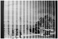 Badlands and parking lot, Visitor Center window reflexion. Badlands National Park, South Dakota, USA. (black and white)