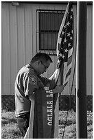 Native American ranger gathering US and Tribal flags. Badlands National Park ( black and white)