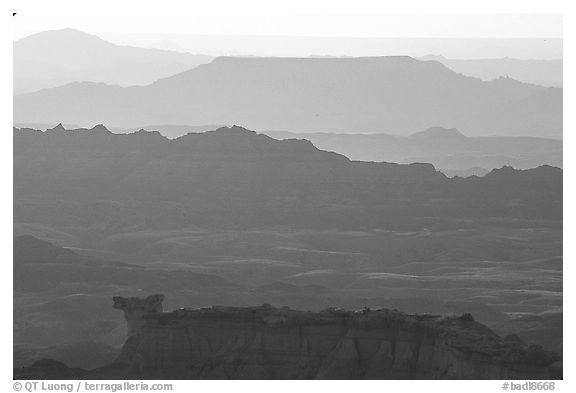 Backlit ridges of the Stronghold table in the southern unit, sunrise. Badlands National Park, South Dakota, USA.