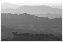 Backlit ridges of the Stronghold table in the southern unit, sunrise. Badlands National Park, South Dakota, USA. (black and white)