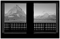 Grinnell Point and Swiftcurrent Lake framed by windows of Many Glacier Lodge. Glacier National Park, Montana, USA. (black and white)