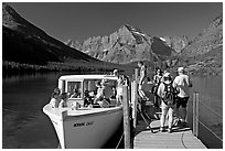 Passengers embarking on tour boat at the end of Lake Josephine. Glacier National Park, Montana, USA. (black and white)