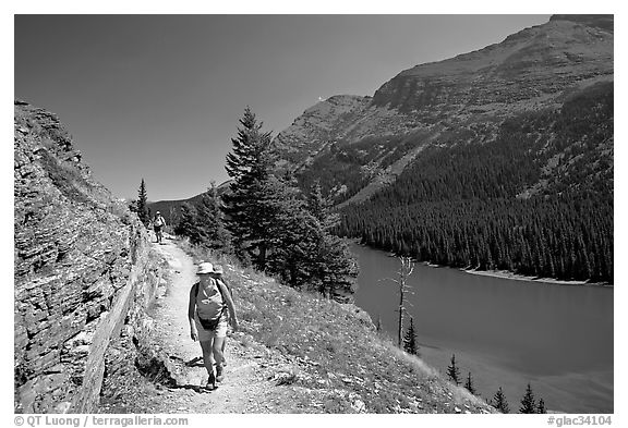 Hikers on trail above Lake Josephine. Glacier National Park, Montana, USA.