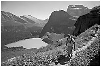 Hikers on trail overlooking Grinnell Lake. Glacier National Park, Montana, USA. (black and white)