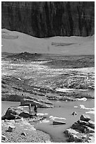 Crossing the outlet stream of the Grinnell glacial lake. Glacier National Park, Montana, USA. (black and white)