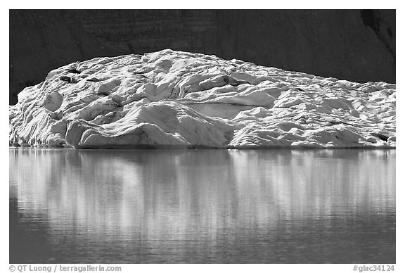 Grinnell Glacier reflected in Upper Grinnel Lake. Glacier National Park, Montana, USA.