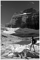 Hiker with backpack surveying Grinnell Glacier. Glacier National Park, Montana, USA. (black and white)