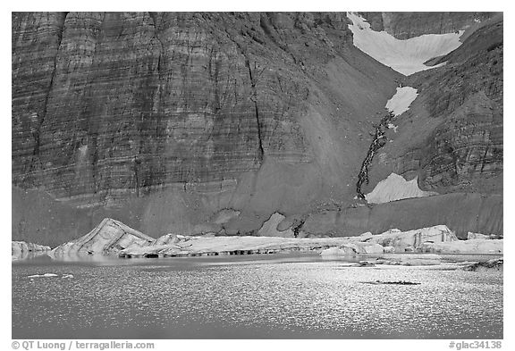 Ripples on Upper Grinnel Lake, with icebergs and glacier. Glacier National Park, Montana, USA.