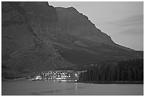 Swiftcurrent Lake and Many Glacier Lodge lights at dusk. Glacier National Park, Montana, USA. (black and white)