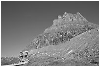 Two backpackers descending on trail near Logan Pass. Glacier National Park, Montana, USA. (black and white)