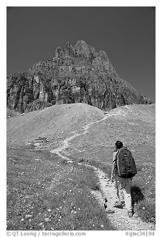 Backpacker and peak near Logan Pass. Glacier National Park, Montana, USA.