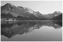 Many Glacier Hotel reflected in Swiftcurrent Lake. Glacier National Park, Montana, USA. (black and white)