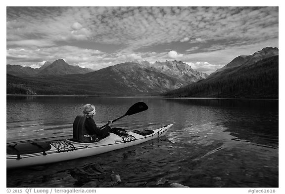Kayaker paddles away from shore, Kintla Lake. Glacier National Park (black and white)