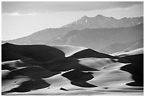 Distant view of dunes and Sangre de Christo mountains in late afternoon. Great Sand Dunes National Park and Preserve ( black and white)