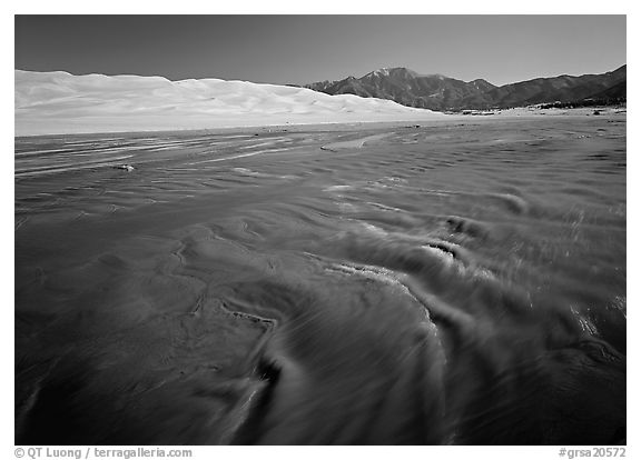 Mendonca creek with shifting sands, dunes and Sangre de Christo mountains. Great Sand Dunes National Park (black and white)