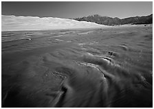 Medano creek with shifting sands, dunes and Sangre de Christo mountains. Great Sand Dunes National Park and Preserve ( black and white)