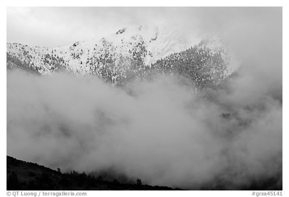 Snowy peak appearing between clouds. Great Sand Dunes National Park and Preserve (black and white)