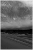 Dunes, moonlit clouds, and stars. Great Sand Dunes National Park, Colorado, USA. (black and white)