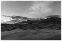 Dune field and Sangre de Cristo mountains with cloud lighted by sunset. Great Sand Dunes National Park, Colorado, USA. (black and white)
