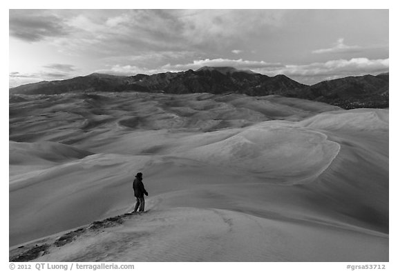 Park visitor looking, dune field. Great Sand Dunes National Park, Colorado, USA.
