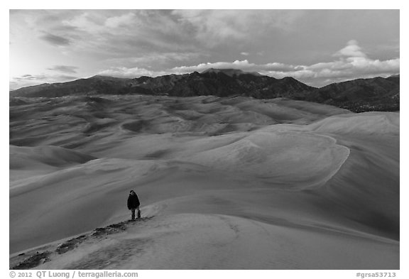 Hiker climbing high dune. Great Sand Dunes National Park, Colorado, USA.