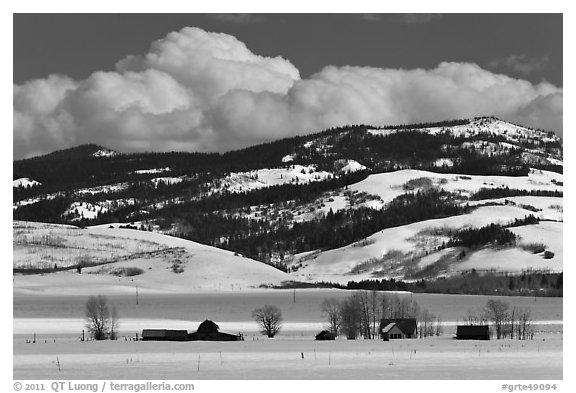Distant row of barns, hills and clouds in winter. Grand Teton National Park (black and white)