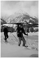 Couple snowshowing with baby. Grand Teton National Park, Wyoming, USA. (black and white)