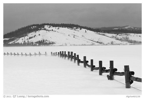 Fence, snowdrift and Ulh Hill. Grand Teton National Park, Wyoming, USA.