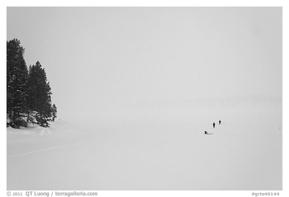 Frozen Jackson Lake in white-out, ice fishermen. Grand Teton National Park, Wyoming, USA.