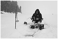 Ice fisherman in white-out, Jackson Lake. Grand Teton National Park, Wyoming, USA. (black and white)