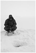 Ice fishing during a snow storm, Jackson Lake. Grand Teton National Park, Wyoming, USA. (black and white)
