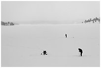 Jackson Lake in winter with ice fishermen. Grand Teton National Park, Wyoming, USA. (black and white)