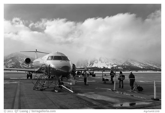 Passengers boarding aircraft, Jackson Hole Airport, winter. Grand Teton National Park, Wyoming, USA.