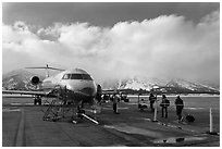 Passengers boarding aircraft, Jackson Hole Airport, winter. Grand Teton National Park, Wyoming, USA. (black and white)