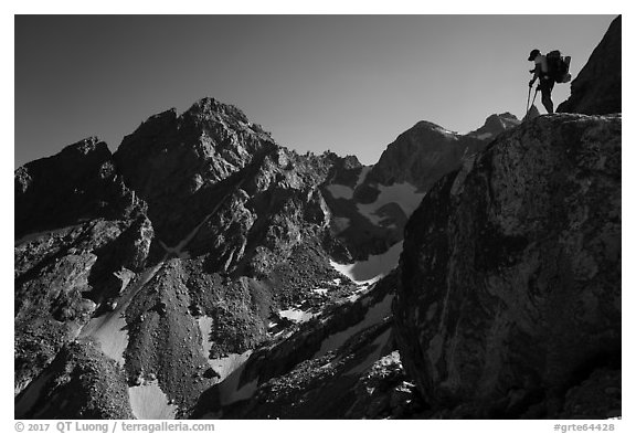 Mountaineer stands on rock looking at peaks, Garnet Canyon. Grand Teton National Park (black and white)
