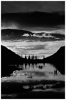 Sunrise with colorful clouds reflected on a pond in Horseshoe park. Rocky Mountain National Park, Colorado, USA. (black and white)