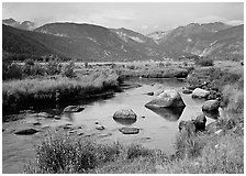 Creek, boulders, and meadow surrounded by mountains, autumn. Rocky Mountain National Park, Colorado, USA. (black and white)