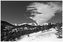 Partly thawed meadow, snowy range, and cloud. Rocky Mountain National Park ( black and white)