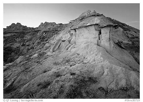 Badlands and caprock formation at sunset, South Unit. Theodore Roosevelt National Park, North Dakota, USA.