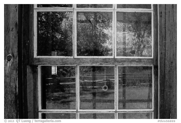 Badlands reflected in Maltese Cross cabin window. Theodore Roosevelt National Park, North Dakota, USA.