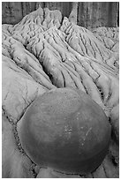 Spherical cannonball concretion in badlands. Theodore Roosevelt National Park, North Dakota, USA. (black and white)