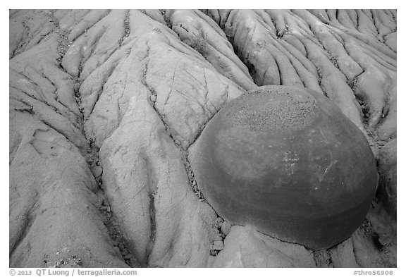 Cannonball concretion partly uncovered by erosion. Theodore Roosevelt National Park, North Dakota, USA.