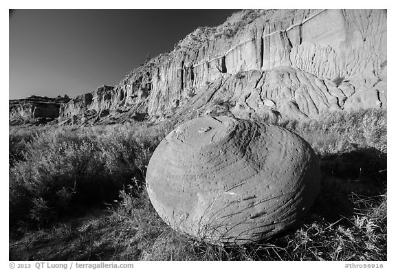 Cannonball in grasses at the base of cliff. Theodore Roosevelt National Park (black and white)