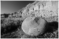 Cannonball in grasses at the base of cliff. Theodore Roosevelt National Park, North Dakota, USA. (black and white)