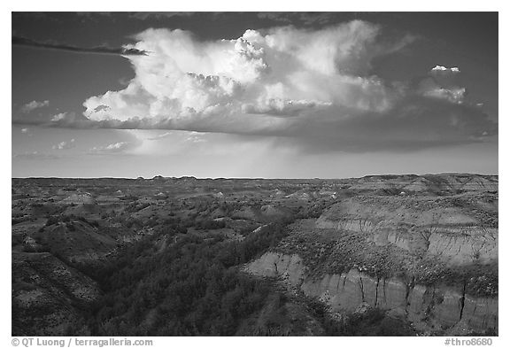 Storm cloud and badlands at sunset, outh Unit. Theodore Roosevelt National Park, North Dakota, USA.