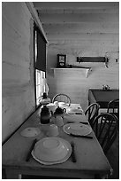 Dining table inside Roosevelt's Maltese Cross Cabin. Theodore Roosevelt National Park, North Dakota, USA. (black and white)