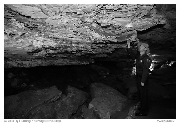Ranger pointing at speleotherm in large cave room. Wind Cave National Park (black and white)