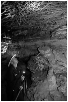 Ranger lights up boxwork in the Elks Room. Wind Cave National Park, South Dakota, USA. (black and white)