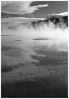 Great prismatic springs, thermal steam, and hill,  Midway geyser basin. Yellowstone National Park, Wyoming, USA. (black and white)