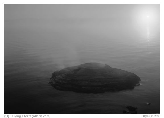 Fishing cone, fog, and sun rising. Yellowstone National Park, Wyoming, USA.